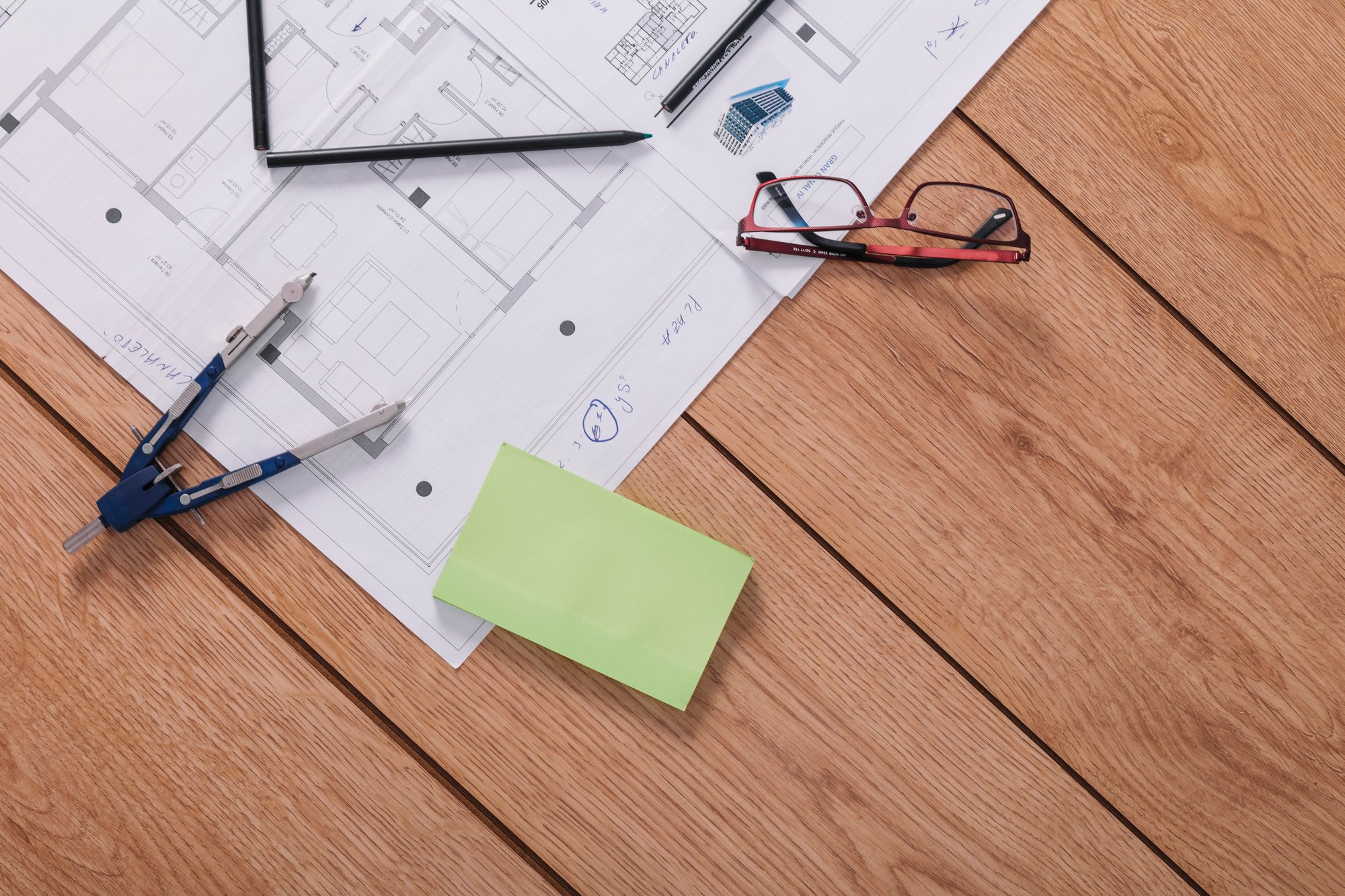 compasses-sticky-notes-near-glasses-drafts