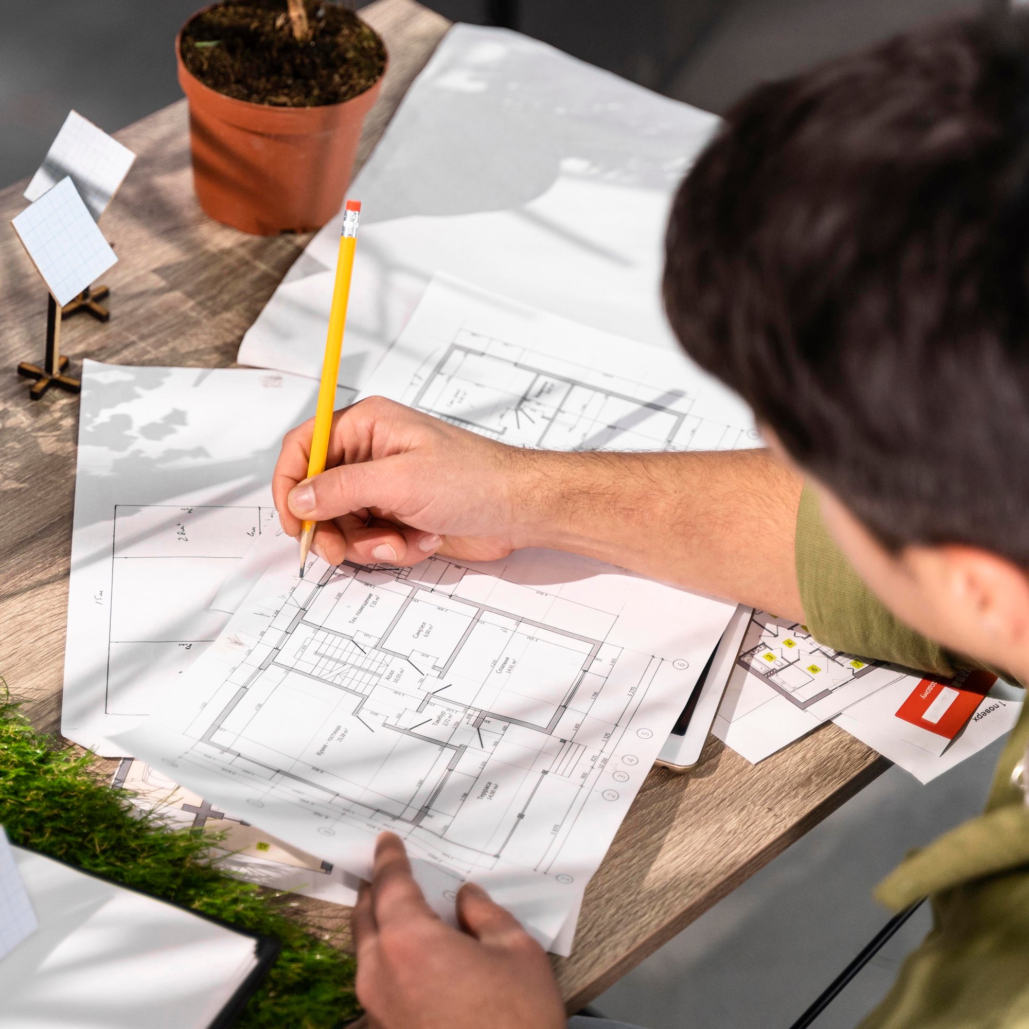 high-angle-man-working-eco-friendly-wind-power-project-with-papers-pencil (1)