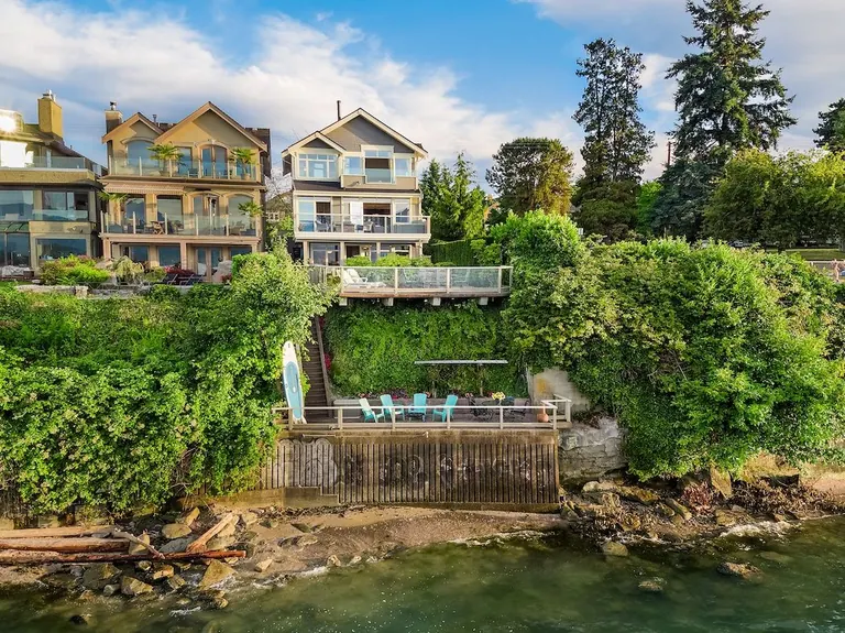 Shingled waterfront houses on Point Grey Road, stepping down to a seawall and beach